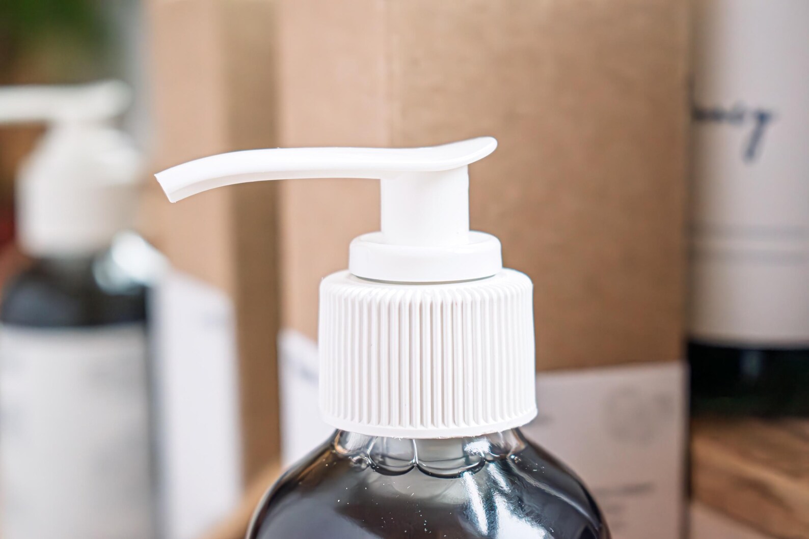 Leafia Skincare Black Honey charcoal cleanser in dark glass bottle with white pump, close-up highlighting dispenser detail