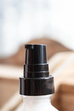 Leafia Skincare Green Tea Face Lotion close-up with black pump on clear glass bottle