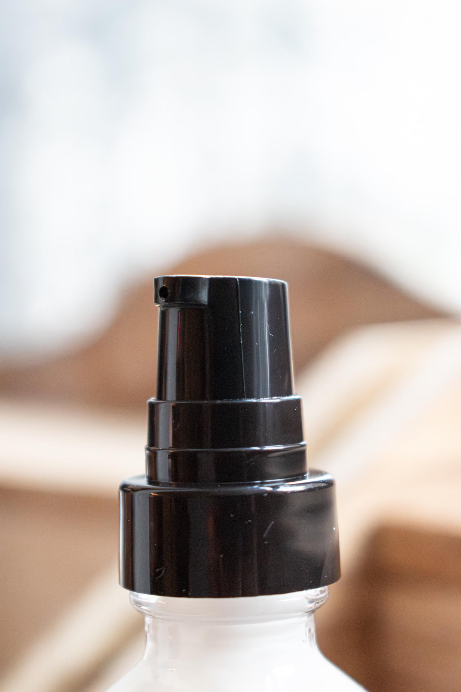 Leafia Skincare Green Tea Face Lotion close-up with black pump on clear glass bottle