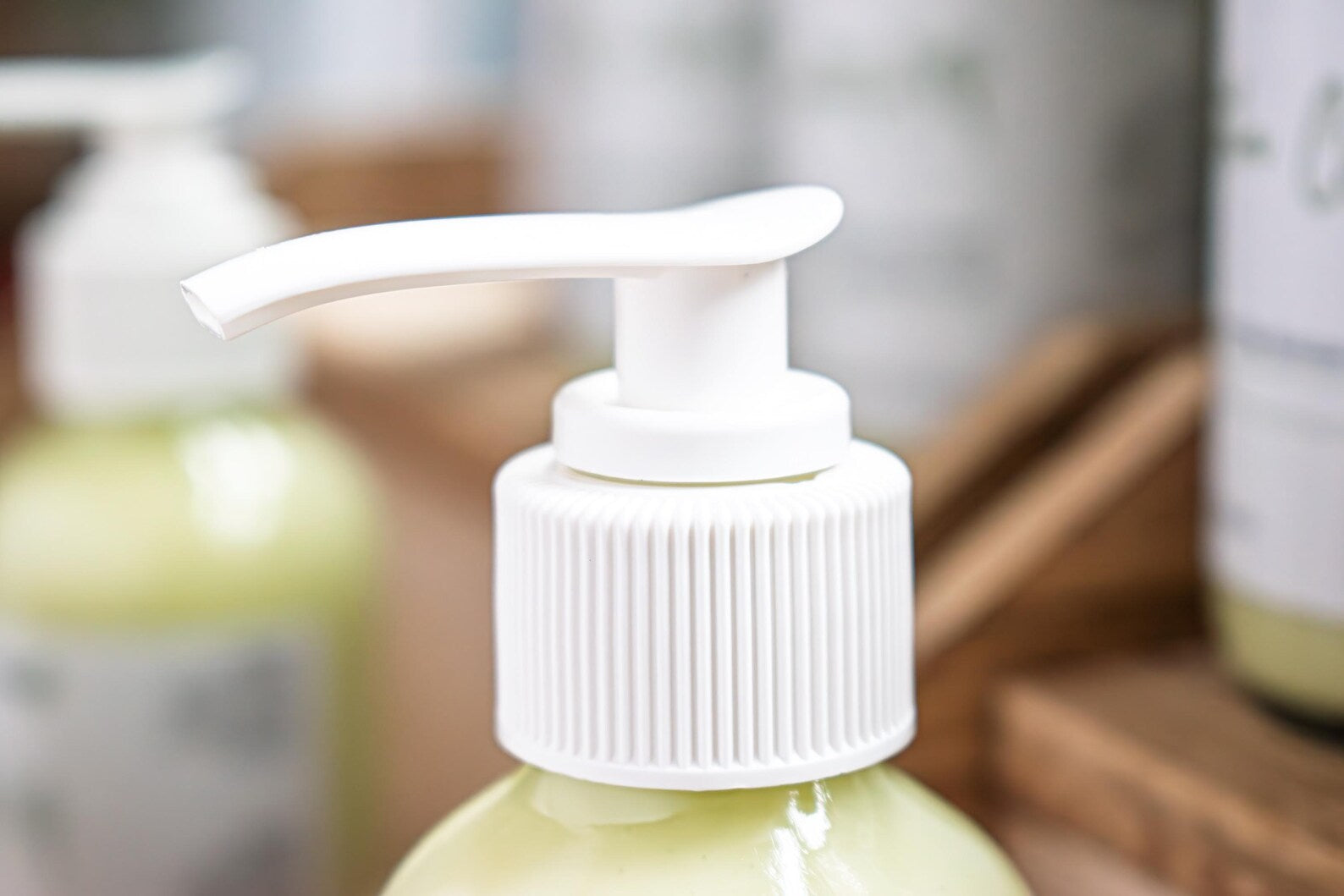 Leafia Skincare Matcha Green Tea gentle cream cleanser in close-up with white pump and soft diffused light