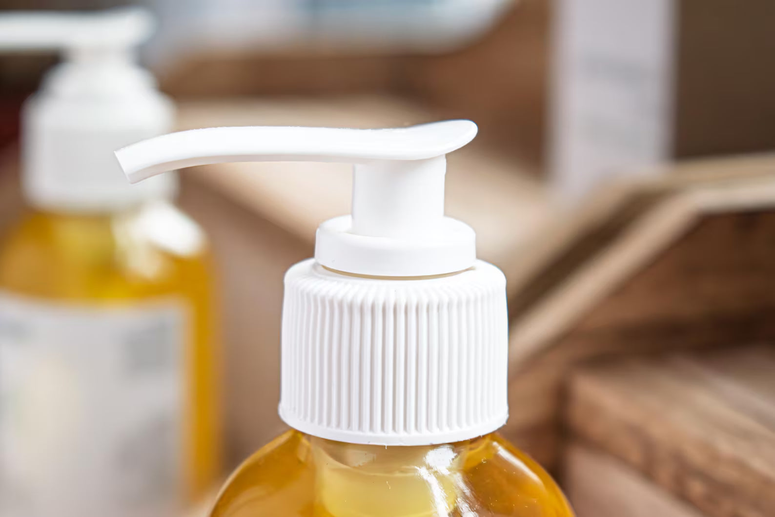Leafia Skincare cleansing oil with apricot and jojoba in clear bottle on natural wood with soft diffused light