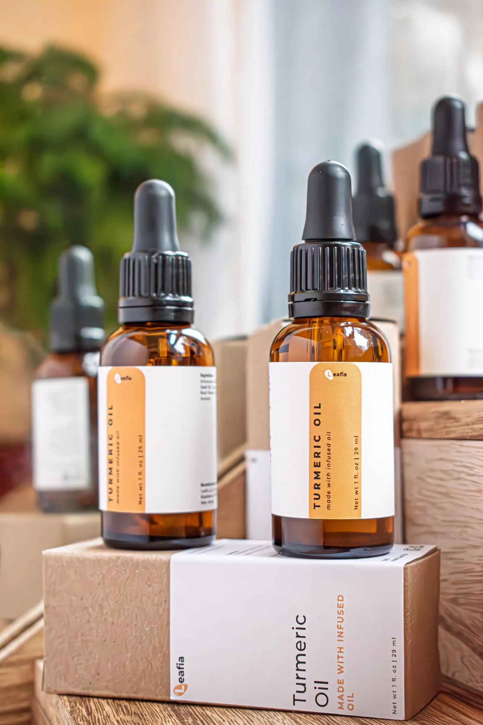 Leafia Skincare turmeric infused facial oil in amber dropper bottle with matching boxes, natural jojoba oil and vitamin E skincare