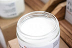 Leafia Skincare Vitamin E Apricot Oil Lotion in open glass jar, close-up showing smooth white cream for face and body hydration
