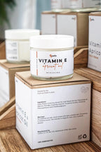 Vitamin E Apricot Oil Lotion by Leafia Skincare in glass jar beside packaging, designed for lightweight daily moisturizing