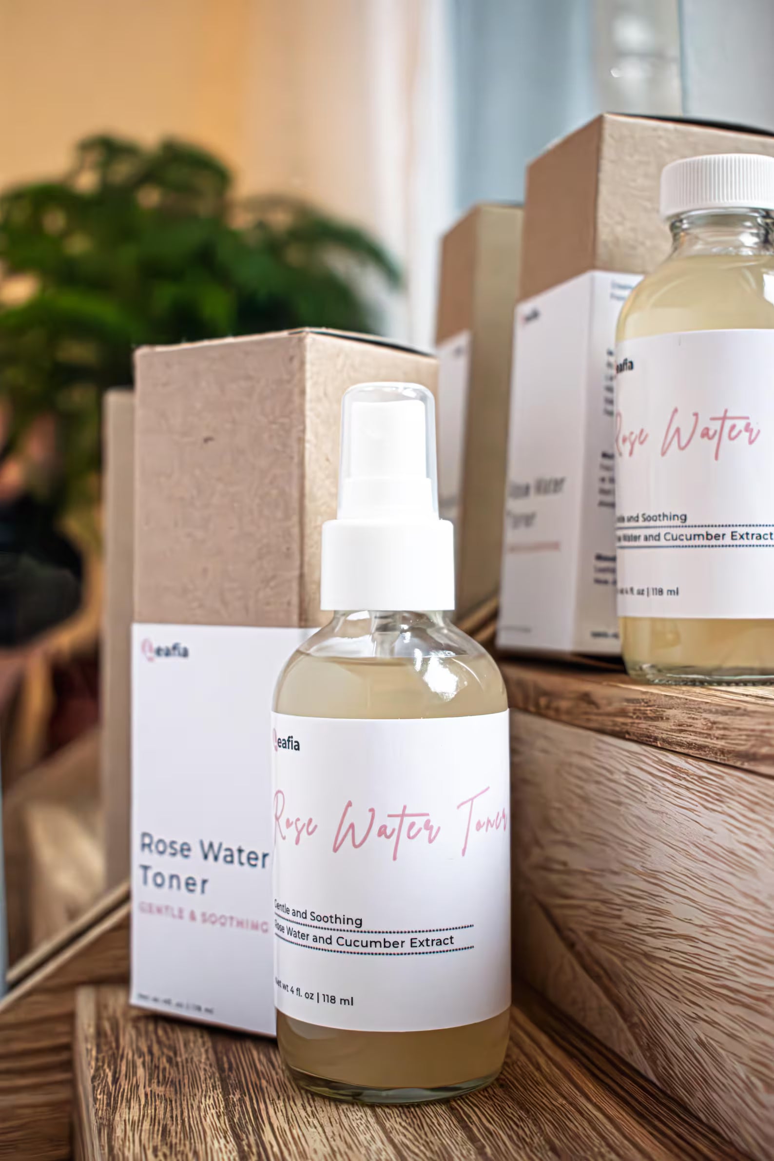 Leafia Skincare Rose Water Toner in glass spray bottle on wooden surface, gentle hydrating mist with rose and cucumber
