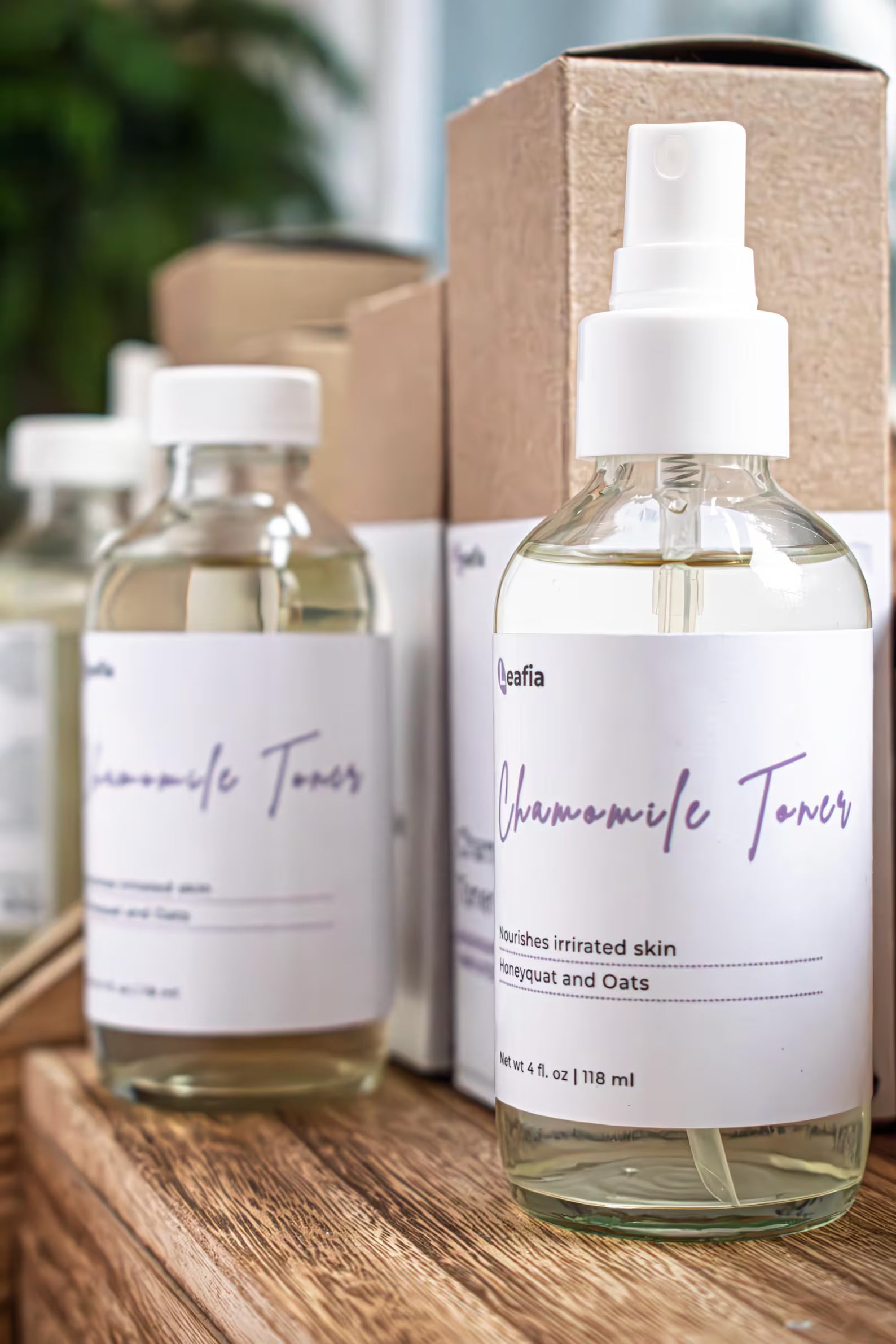 Leafia Skincare chamomile toner bottles on wooden surface with minimalist packaging in soft natural light