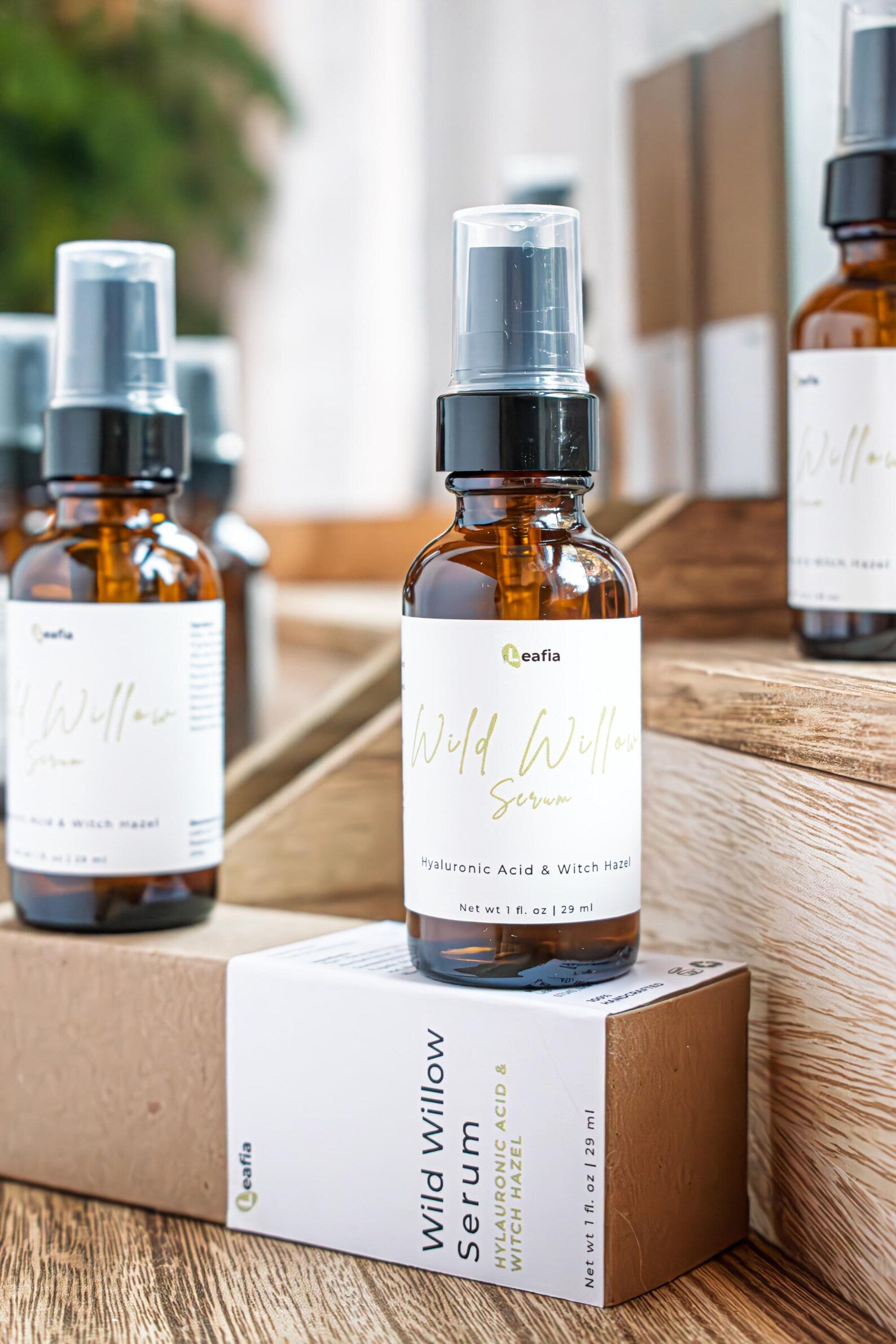 Leafia Skincare Wild Willow niacinamide serum with packaging on layered wood trays, clean label and earthy apothecary aesthetic