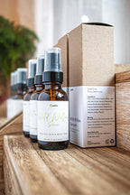 Leafia Skincare Wild Willow facial serum in amber pump bottles with recycled boxes on rustic wood in warm natural light
