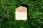 pink and white soap on a grass background