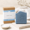 Blue handmade soap bar with packaging labeled 'Deep Sea' on a neutral background