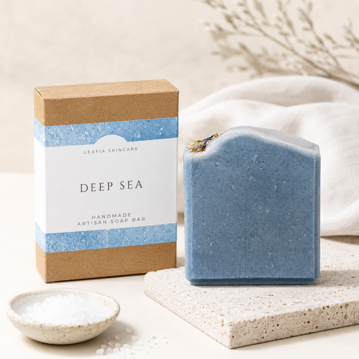Blue handmade soap bar with packaging labeled 'Deep Sea' on a neutral background