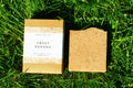 Two soap bars on grass, one with a label 'Sweet Banana'.