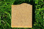 Square piece of  soap on green grass