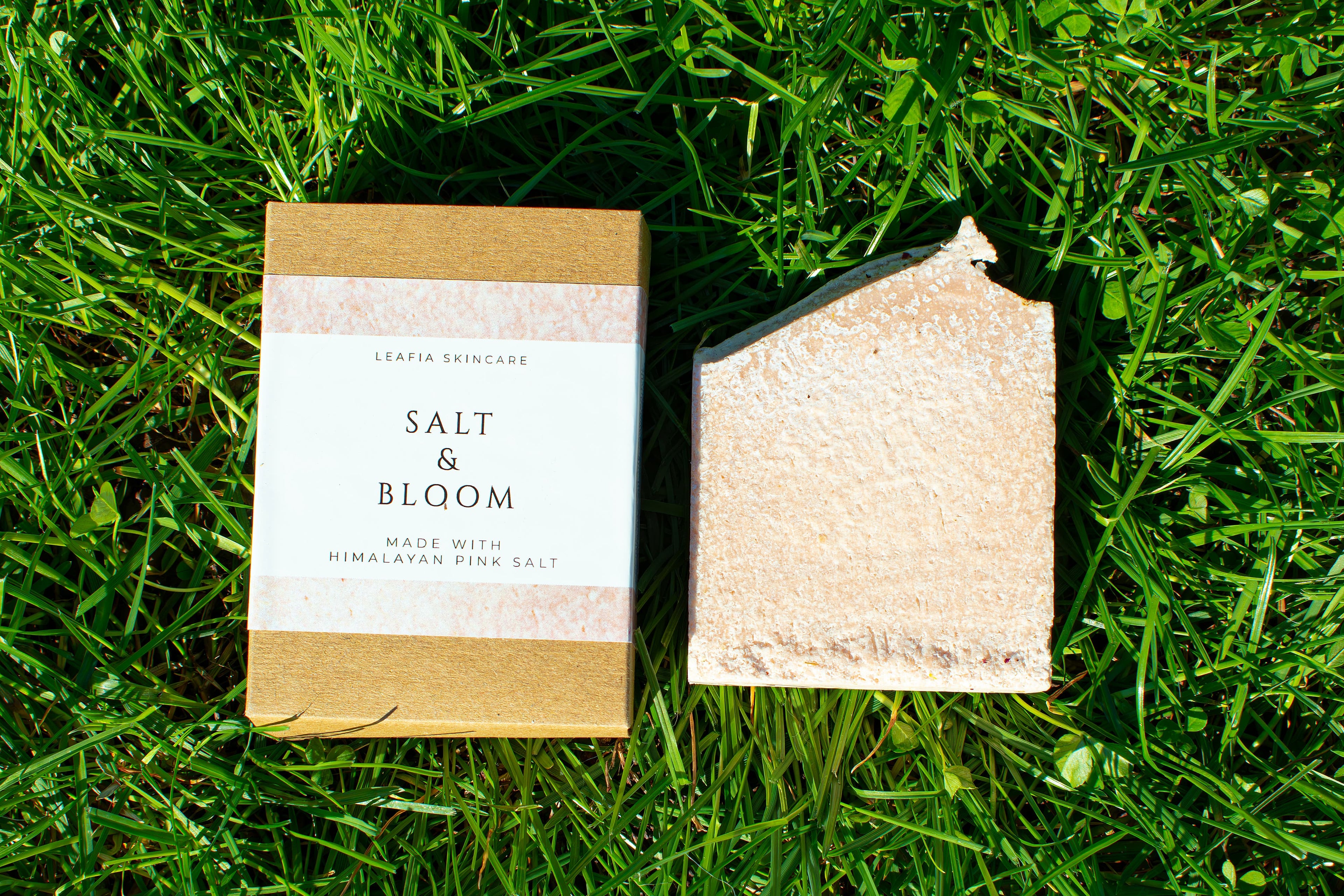 Product packaging on grass with 'Salt & Bloom' label