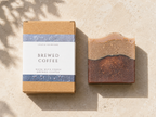 Bar of soap and packaging labeled 'Brewed Coffee' on a beige background