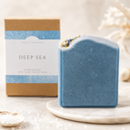 Blue handmade soap bar with packaging labeled 'Deep Sea' on a light background